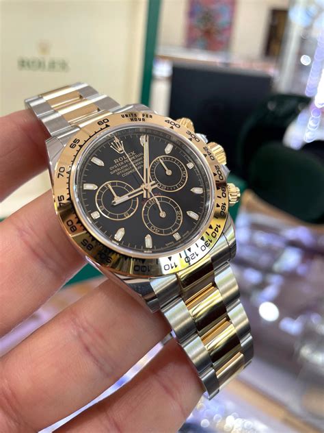 rolex daytona two tone gold dial black ring